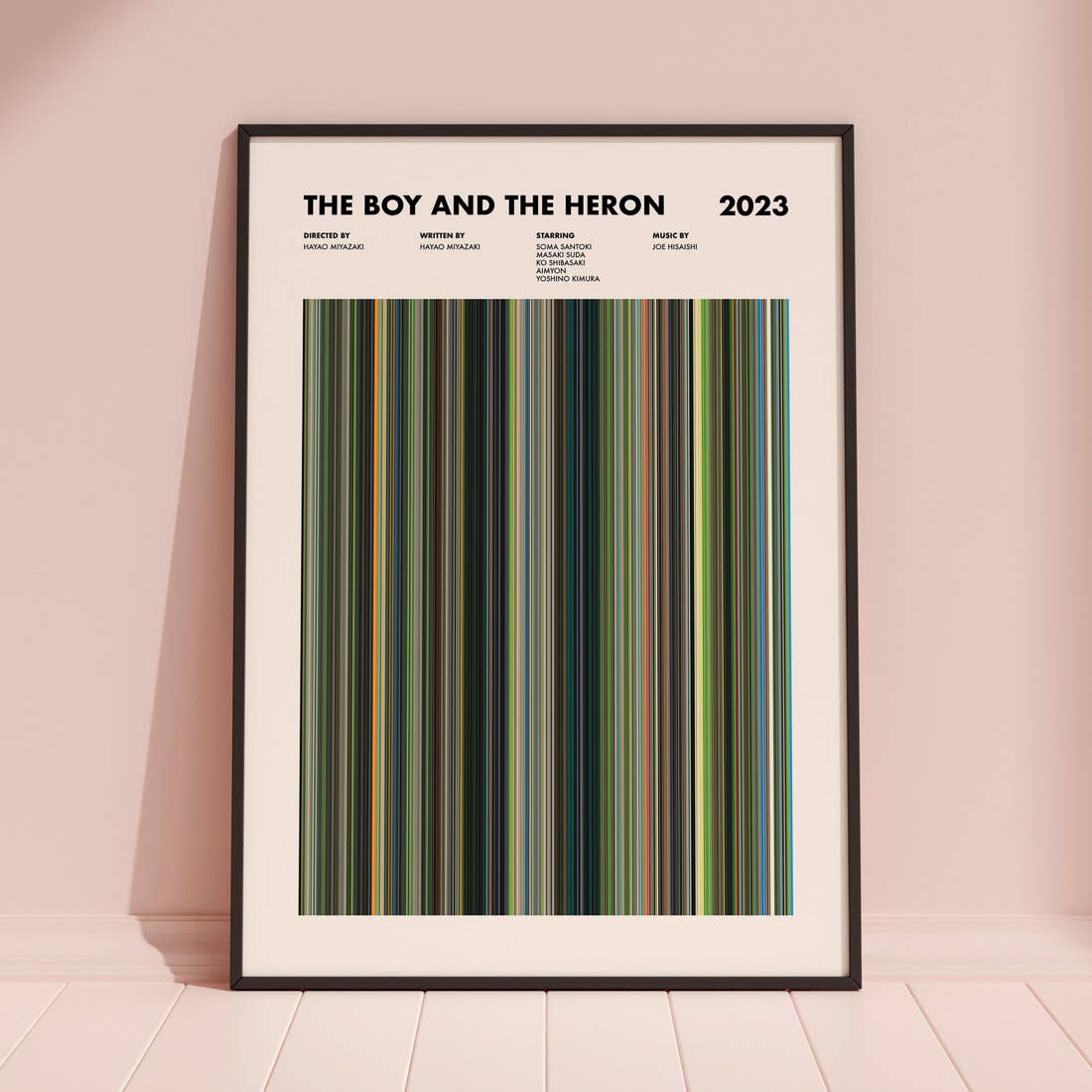 The Boy and the Heron Movie Barcode Poster framed and leaning against a coloured wall