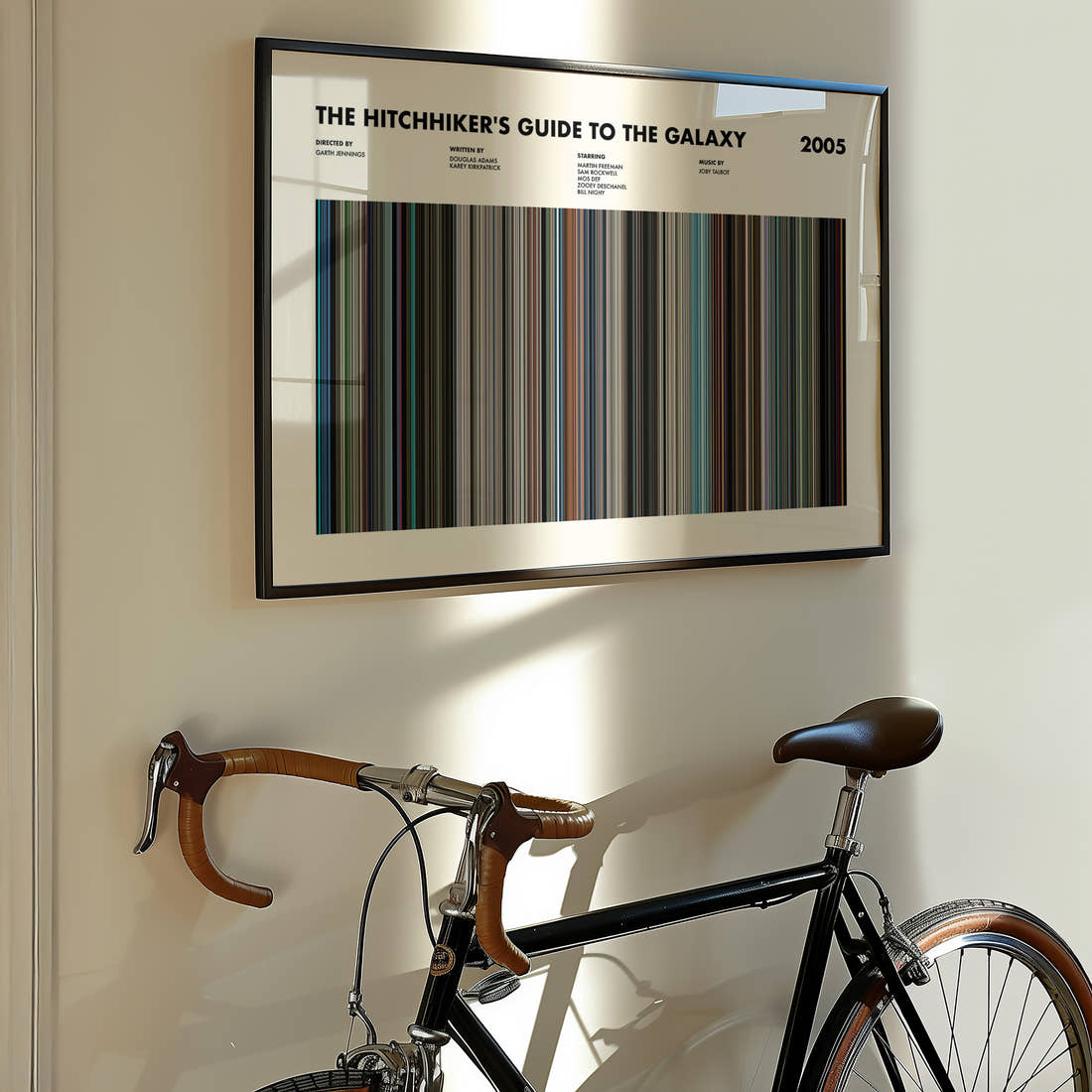 The Hitchhikers Guide To The Galaxy Movie Barcode Poster framed on the wall of a styled room setting