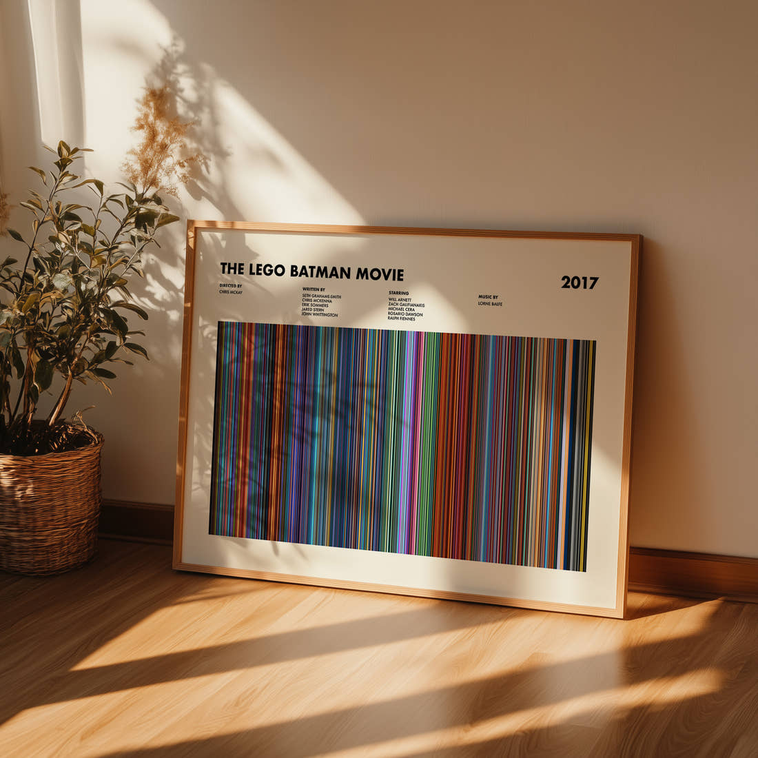 The Lego Batman Movie Barcode Poster framed and leaning against a wall on a wooden floor