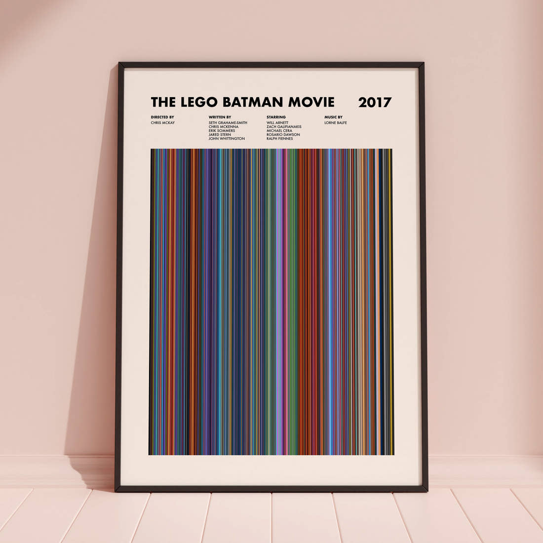 The Lego Batman Movie Barcode Poster framed and leaning against a coloured wall