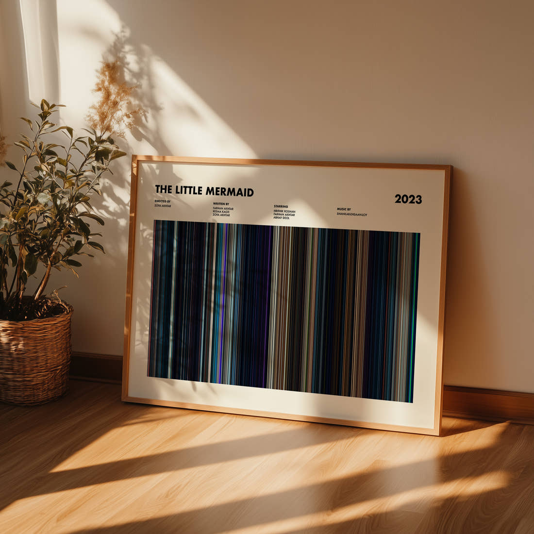 The Little Mermaid 2023 Movie Barcode Poster framed and leaning against a wall on a wooden floor