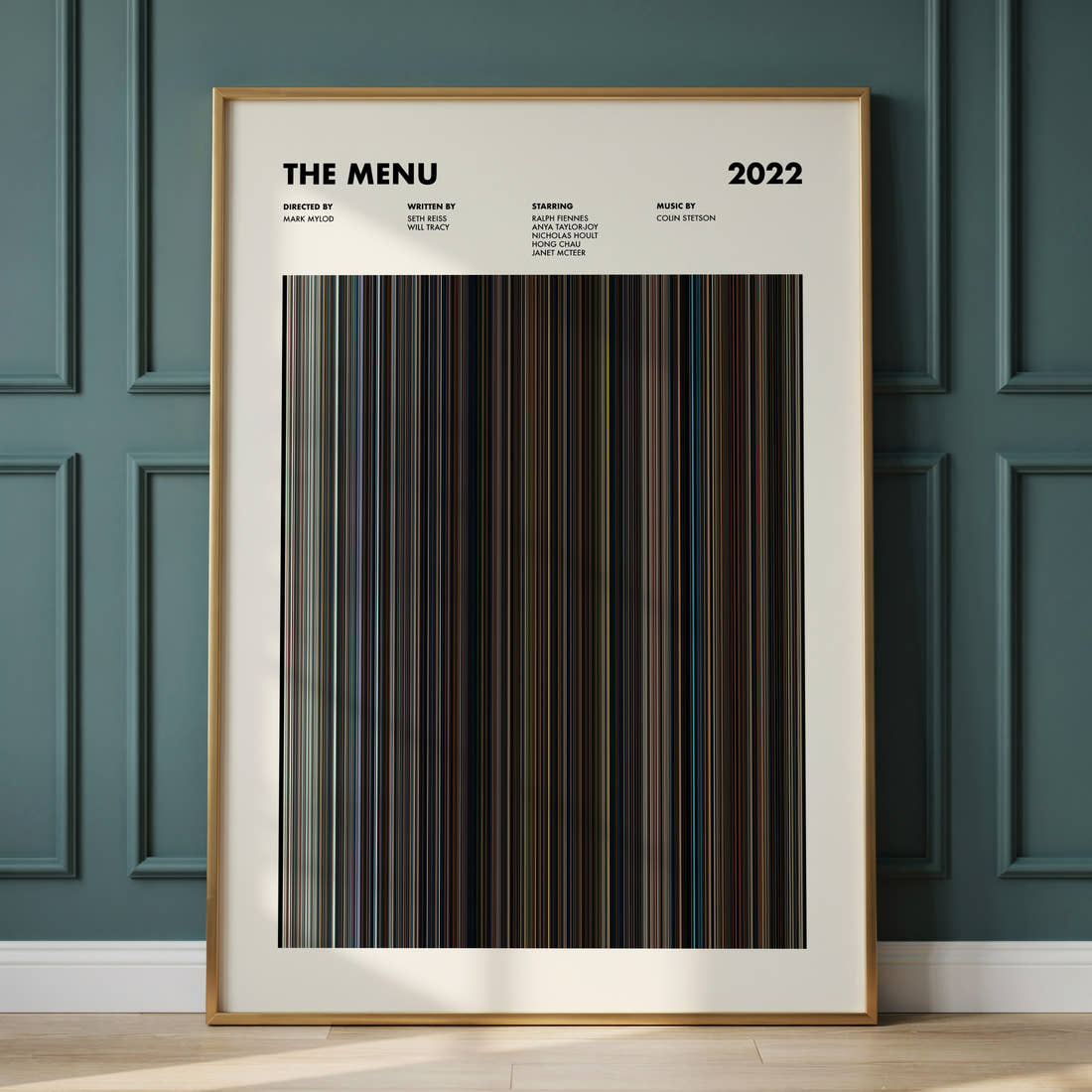 The Menu Movie Barcode Poster framed and leaning against a panelled wall