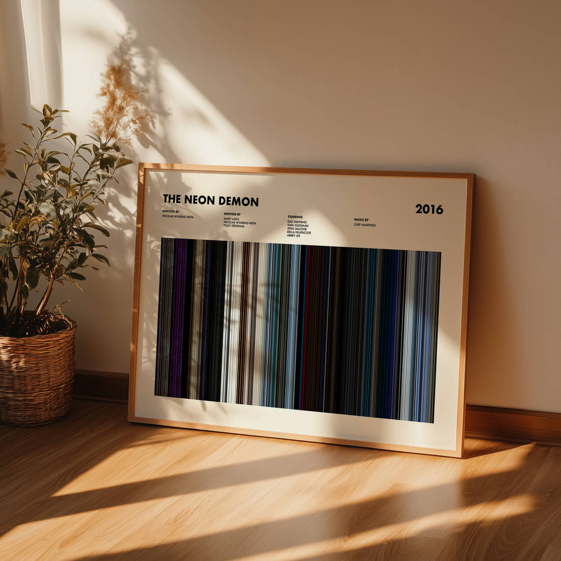 The Neon Demon Movie Barcode Poster framed and leaning against a wall on a wooden floor