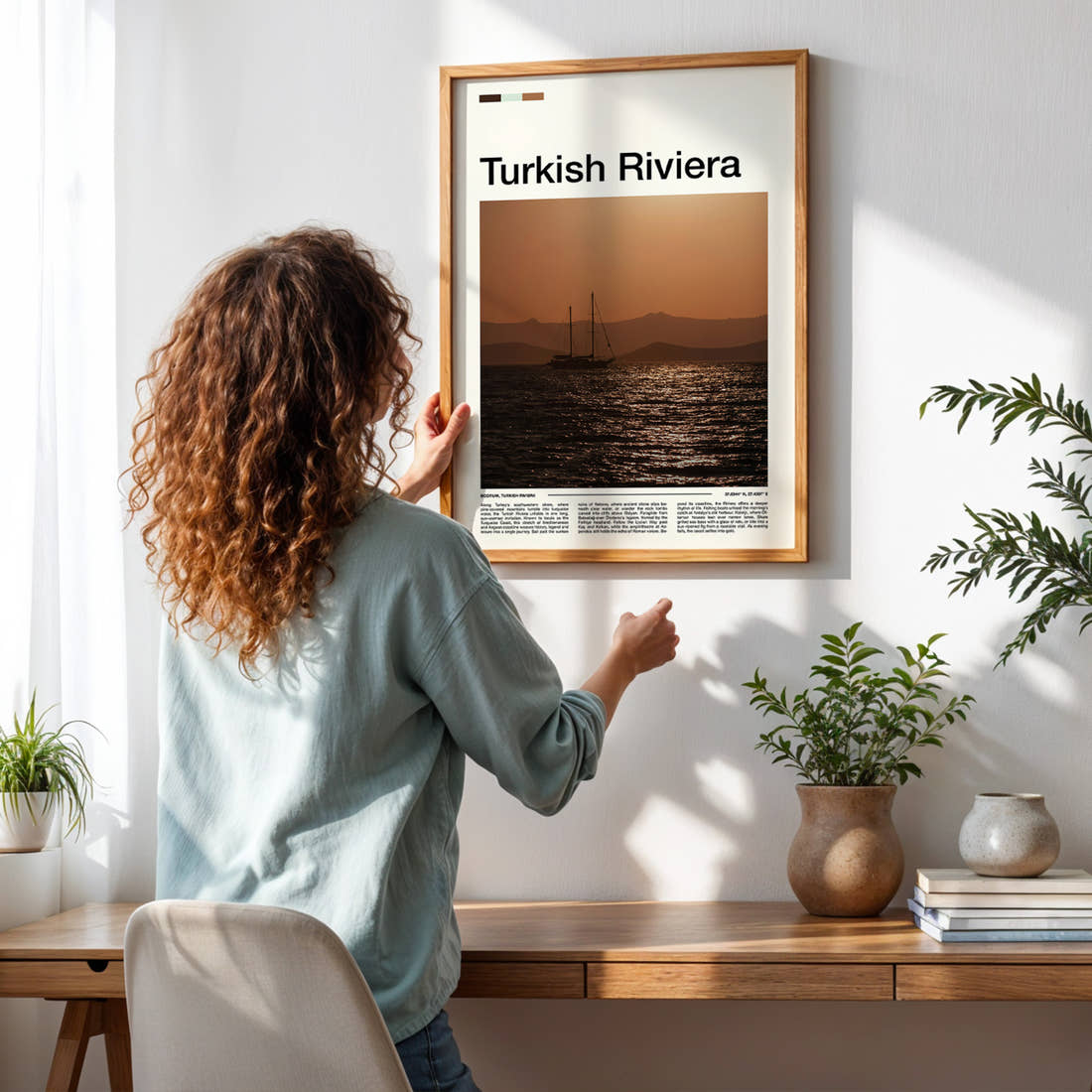 Turkish Riviera Sunset Sailing Boat Travel Print framed on a pale wall beside houseplants