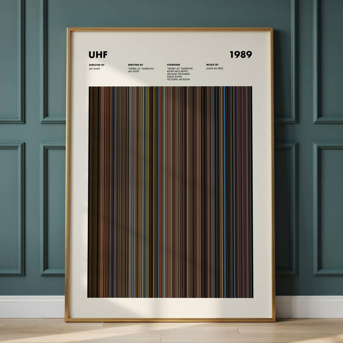 UHF Movie Barcode Poster framed and leaning against a panelled wall