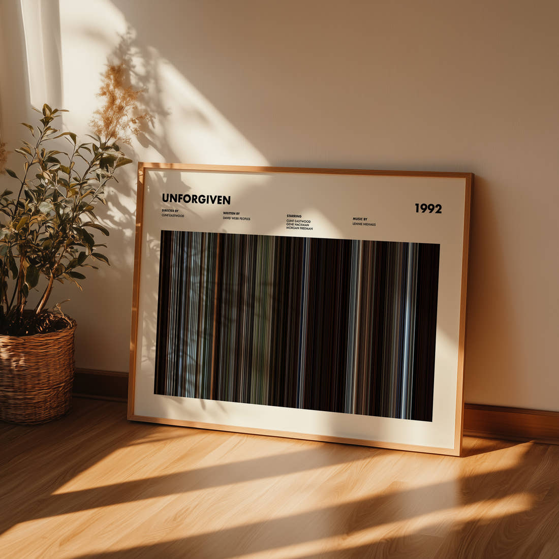 Unforgiven Movie Barcode Poster framed and leaning against a wall on a wooden floor