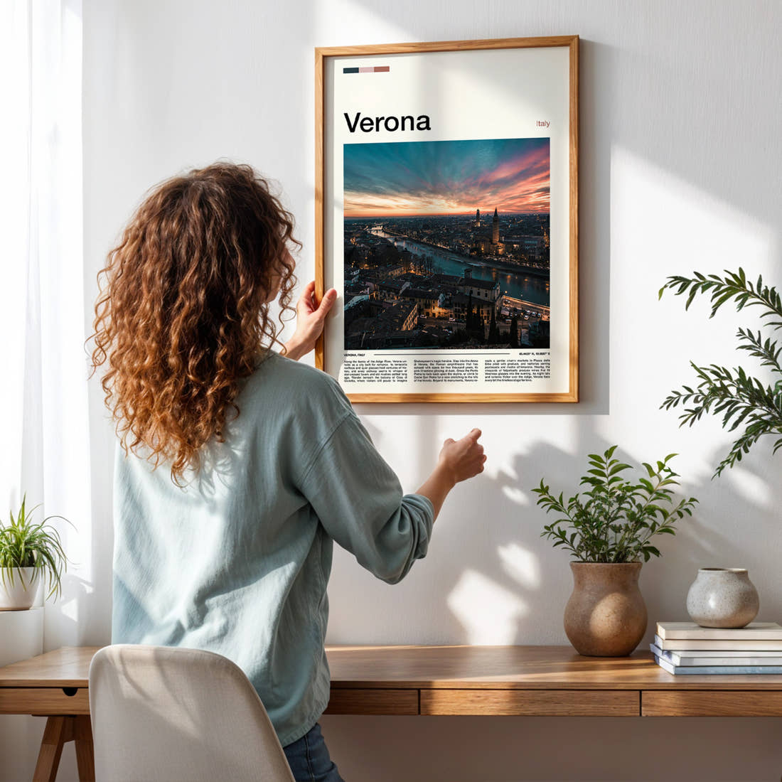 Verona Riverside Skyline Sunset Travel Print framed on a pale wall beside houseplants