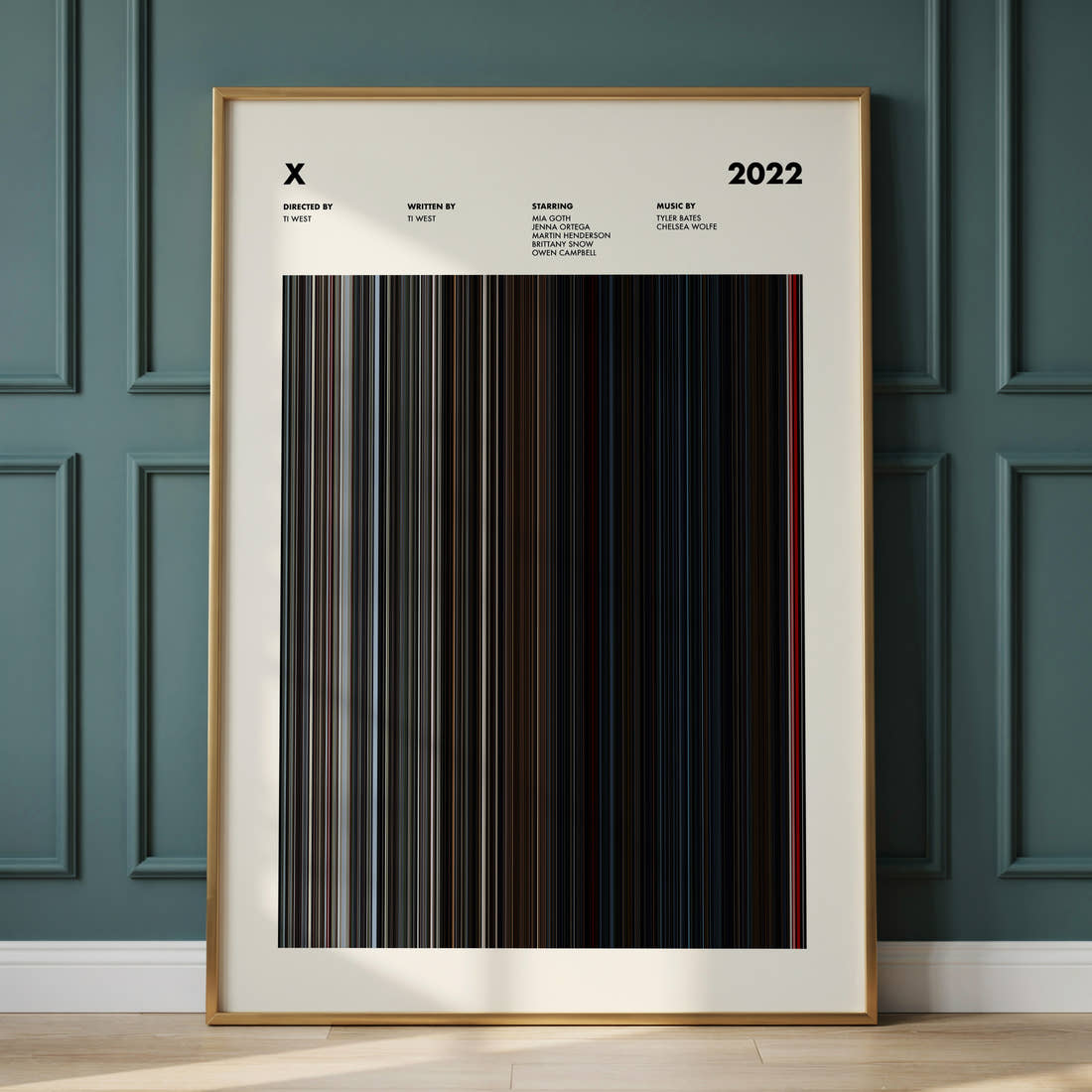 X Movie Barcode Poster framed and leaning against a panelled wall