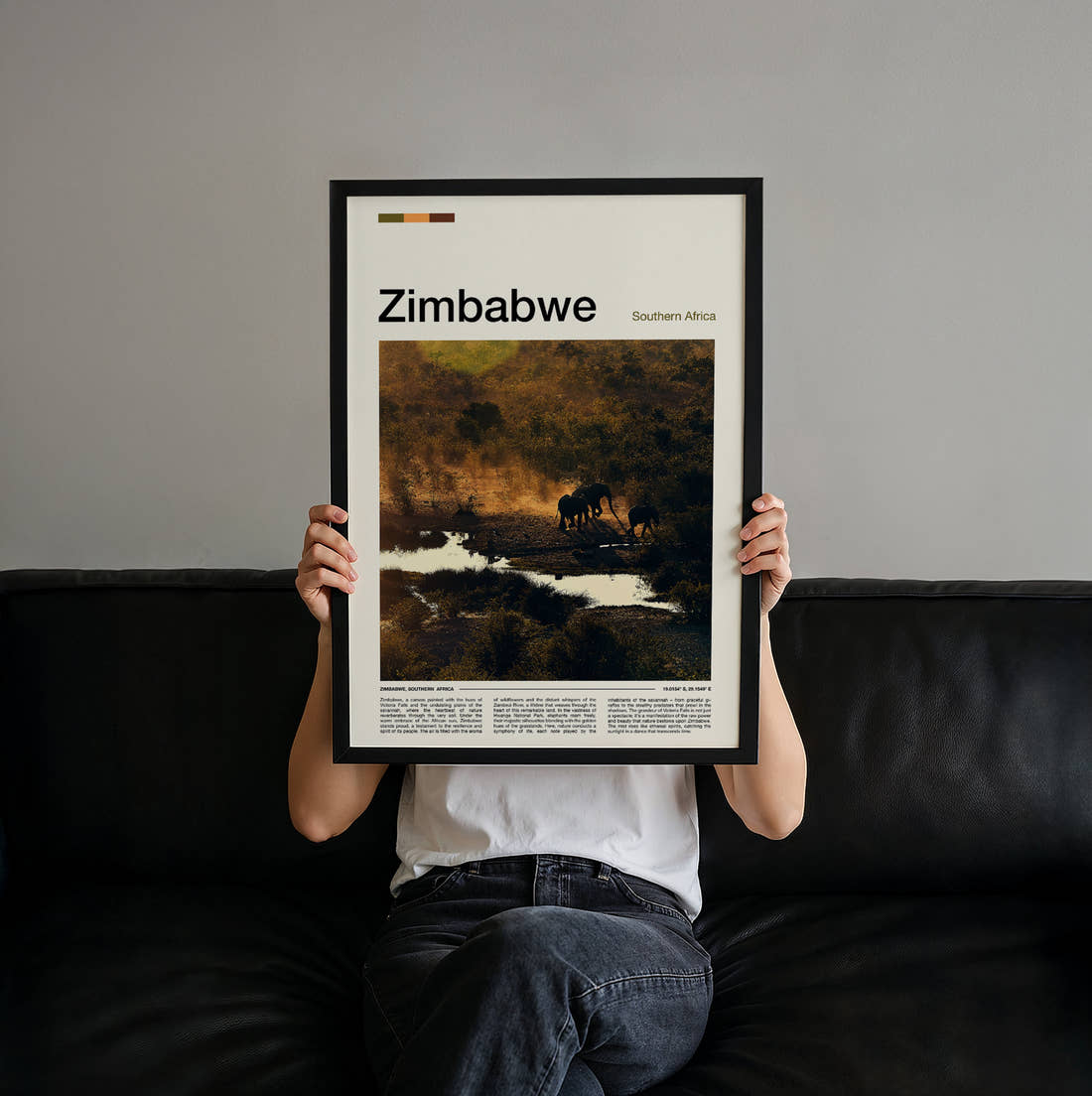 Zimbabwe Elephants By The River Travel Print held up by hand to show the size of the print